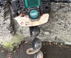 Portable petrol powered hole drilling hand operate