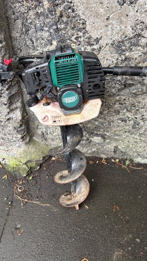 Portable petrol powered hole drilling hand operate