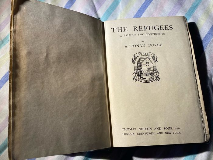 book the refugees: a tale of two continents with the dextrogyre swastika on it