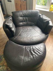 Large circular leather swivel chair and foot stool