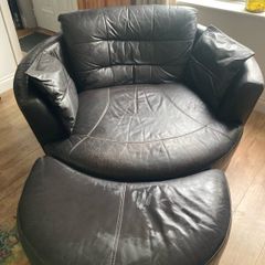 Large circular leather swivel chair and foot stool
