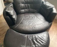 Large circular leather swivel chair and foot stool