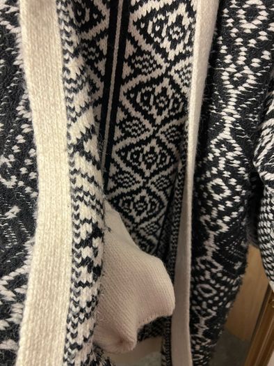 Reversible knitted piece cardigan, a structured jacket, or a coat. Very warm.