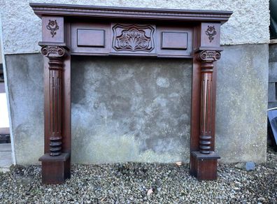 Wooden fireplace surround with carved details