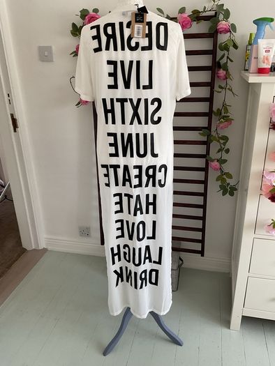 long tunic with side slits Bnwt.  Short sleeve white with black logo