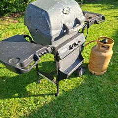 Gas barbecue and bottle.