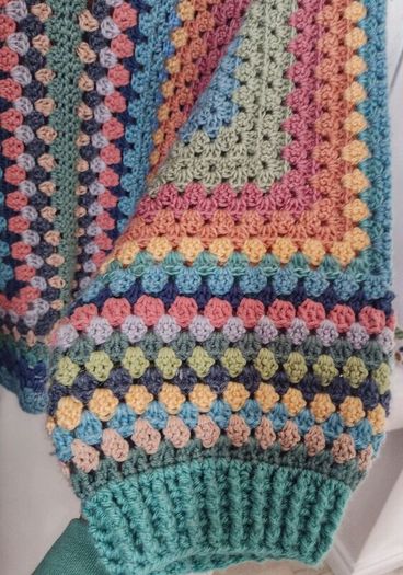 Crocheted colourful hexagon jacket