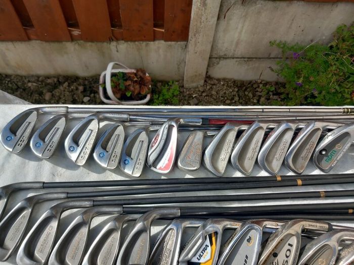 A selection of Golf clubs. Bags and golf balls.