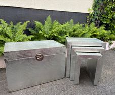 3 silver coloured tables and chest