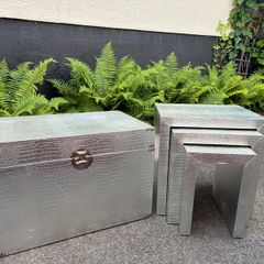 3 silver coloured tables and chest