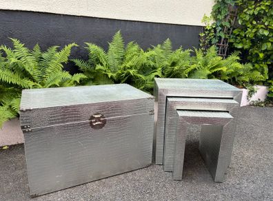 3 silver coloured tables and chest