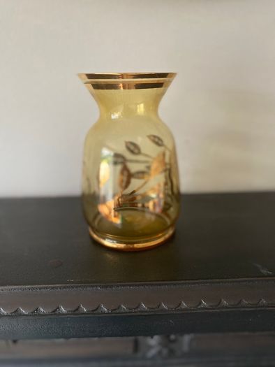 Vintage glass vase with gold decorations.