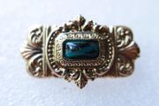 Vintage gold tone brooch with Green Faceted Stone