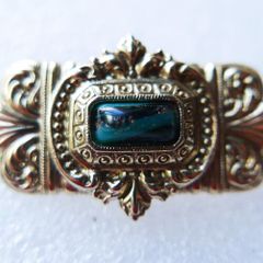Vintage gold tone brooch with Green Faceted Stone