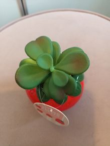 Faux succulent in strawberry vase