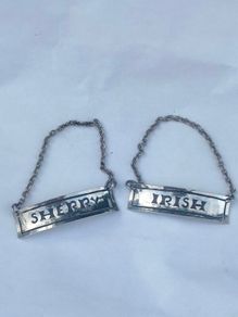 A pair of early 20th century decanter labels