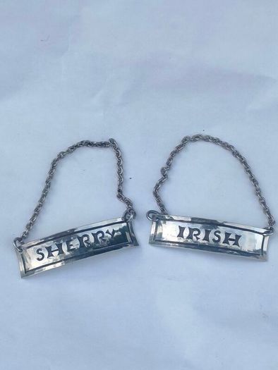 A pair of early 20th century decanter labels