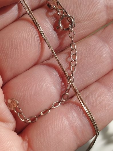 Handcrafted 925 sterling silver necklace with a heart-shaped pendant featuring a floral pattern.