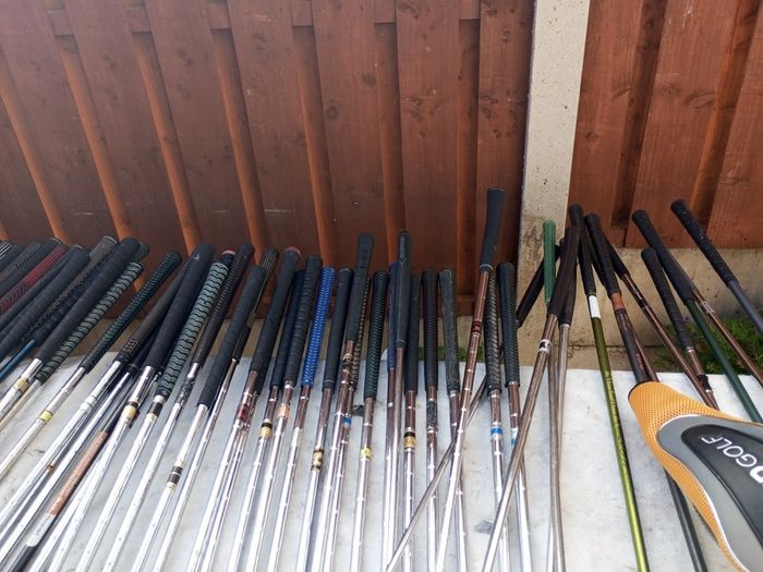 A selection of golf clubs and bags. All right handed clubs.