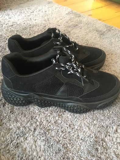 Black trainers bought in Boutique in London