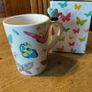 Butterfly Shaped Handle Ceramic Mug, decorated with various colorful butterfly graphics. 3D ceramic butterfly molded directly onto the handle. New in Box. Image 5