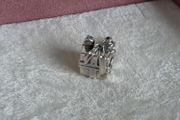 Pandora gleaming gift charm with decorative star/bow on top very good condition