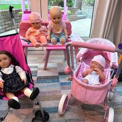 Two toy doll prams and 4 baby dolls