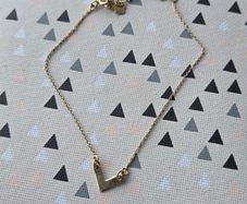 925 sterling silver bracelet with yellow gold plating and V shaped pendant.