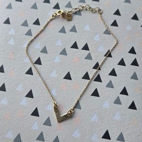925 sterling silver bracelet with yellow gold plating and V shaped pendant.