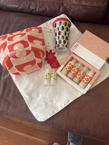 A Bundle of Orla Kiely Products - Bergamot Mini bath and hand set , a pull string wash bag, 2 empty body lotion and conditioner and a limited edition travel porcelain cup for Kenco