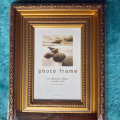 Gold-colored photo frame.