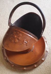 Arts and Crafts era embossed copper helmet coal scuttle with dish