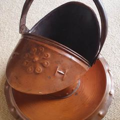 Arts and Crafts era embossed copper helmet coal scuttle with dish