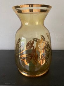 Vintage glass vase with gold decorations.