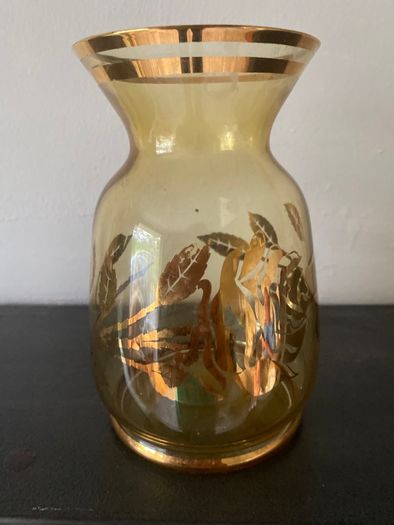 Vintage glass vase with gold decorations.