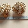 Vintage clip-on earrings with a cluster of faux pearls and gold-tone beads. Image 3