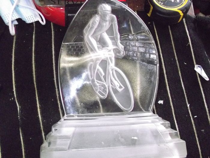 a cut glass with a cycle on it