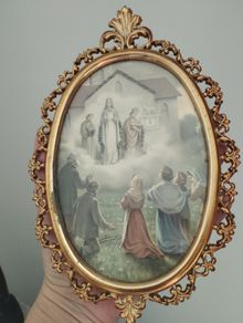 An antique-style painting set in an ornate, gold-toned frame.