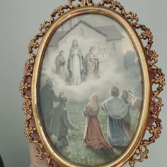 An antique-style painting set in an ornate, gold-toned frame.