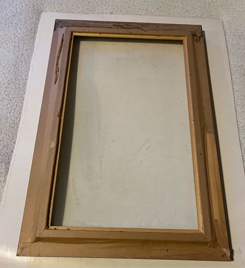 frame A rich dark-wood and gilt picture frame featuring a textured fabric mat liner.