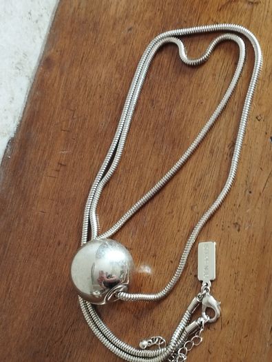 BEN DE LISI long necklace with a ball pendant.