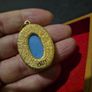 Vintage Cameo Goldtone Pendant on a Blue Background Image 6