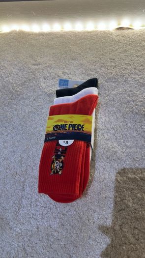 Set of 3 pairs of licensed One Piece socks featuring Straw Hat Pirates graphics.