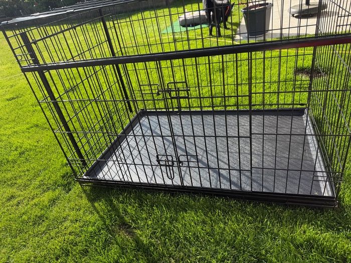 XL dog crate opens up by sliding doors at front and side. Read caption