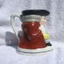 An antique TOBY JUG (Staffordshire potteries) - a seated toby holding his ale jug and cup (late 19th century). Excellent condition. About 14cm height. Image 3