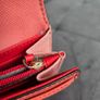 Michael Kors red and pink wallet with gold-tone MK logo. Multiple card slots and a zipped coin compartment. In perfect condition apart from some minor wear inside, which is not noticeable when using it, as shown in the photos. Image 7