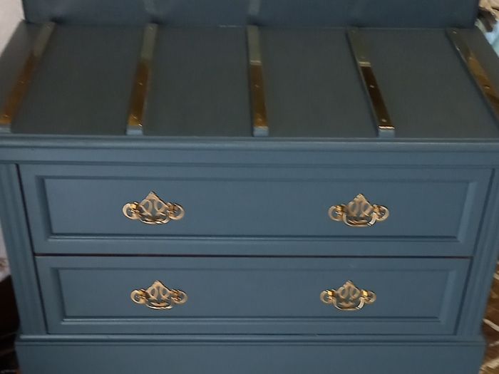 Chest drawers with brass strip suitcase set down