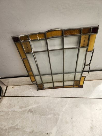 Vintage leaded glass with curved brass screen .