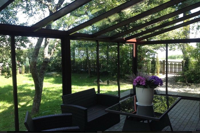 Tempered glass pergola with sliding door