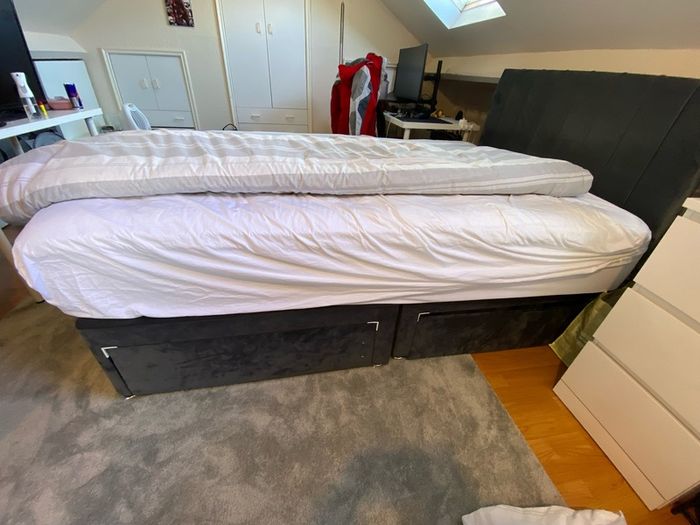 Grey double bed and mattress